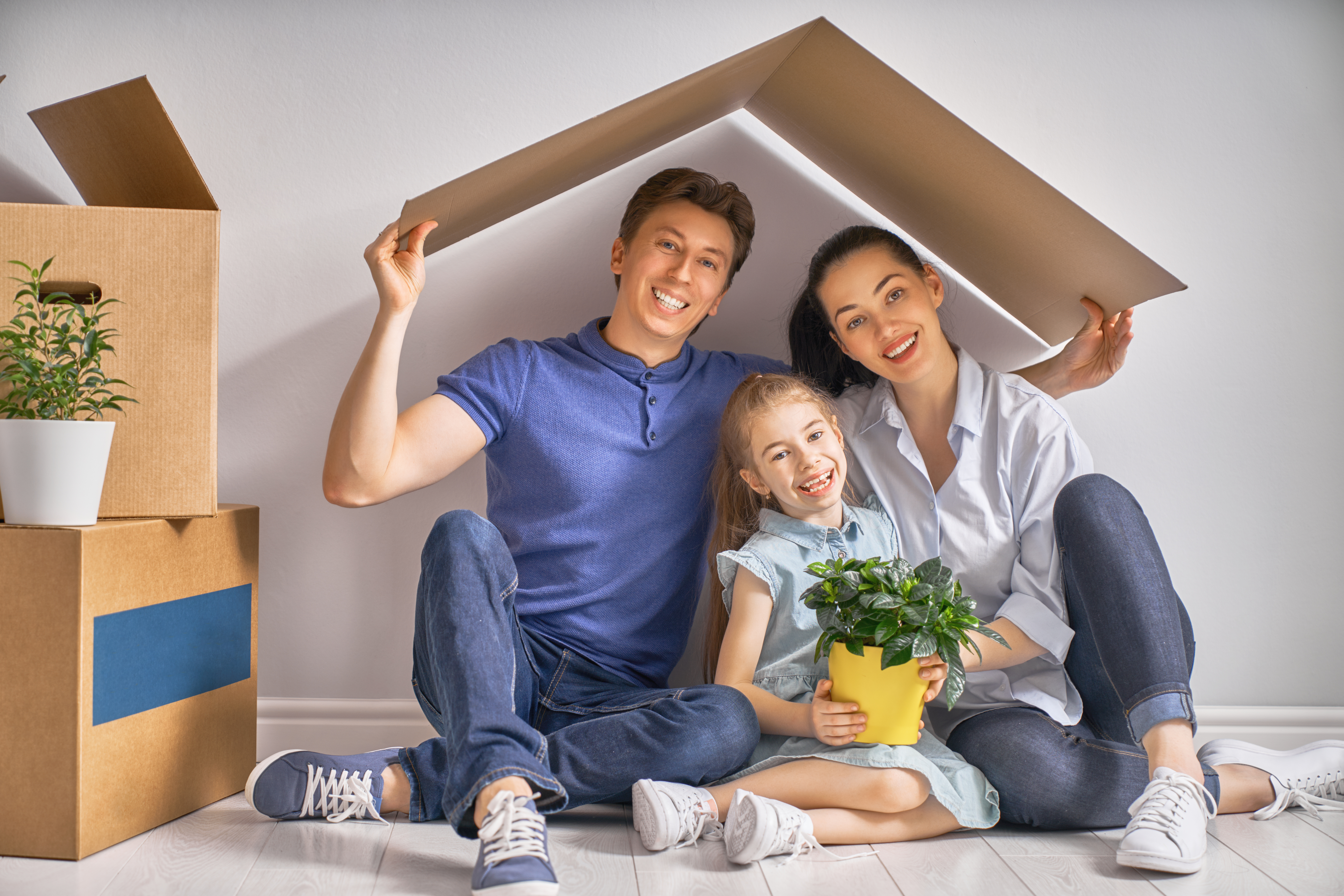 Concept of housing for family Mother, father and child girl in the house with a symbol of roof. Concept of housing for young family.